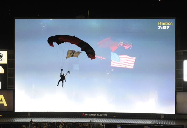 A member of the U.S. Army Black Daggers parachuted down at the start of the game.